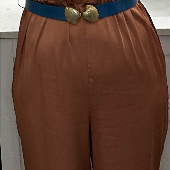 This silky romper is super cute. I am 5’5” & 135 lbs. it’s a salmon/ginger color - Picture 3 of 7